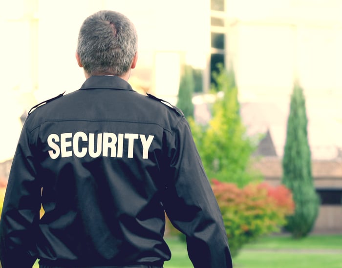 Security guard in front of a haunted house attraction